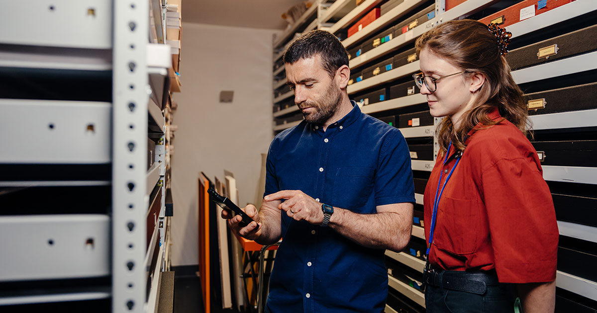 Two staff members in the collection store