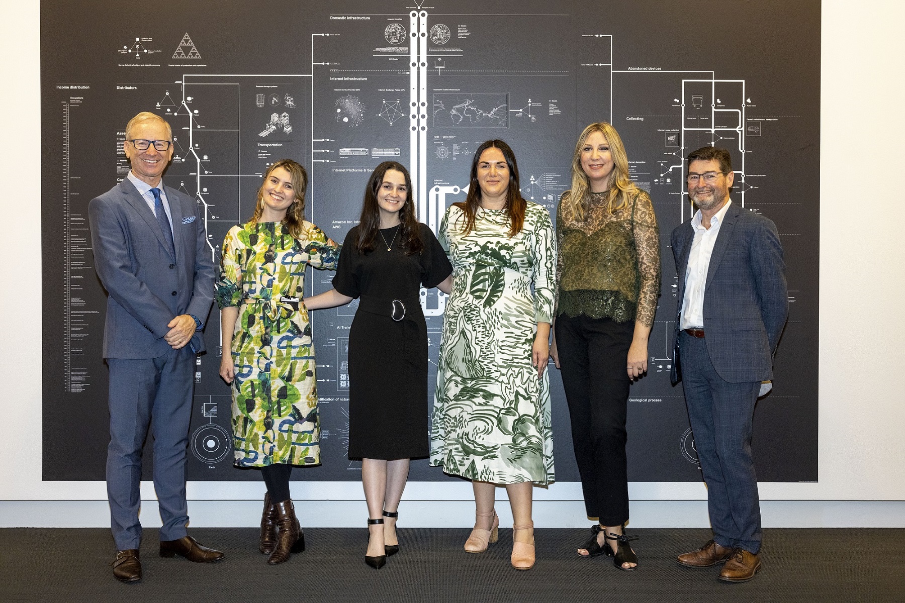 Professor Tim Dunne stands next to members of the curatorial team