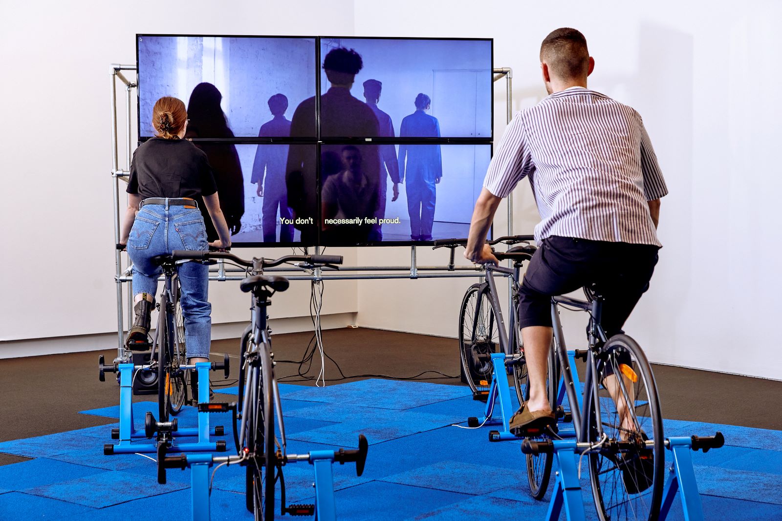 Adam and a colleague on bicycles that are part of an artwork