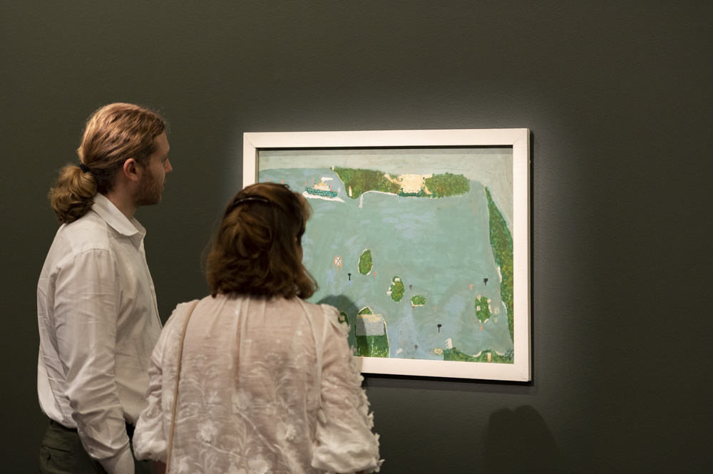 Two people looking at the painting Moreton Bay by Charles Callins