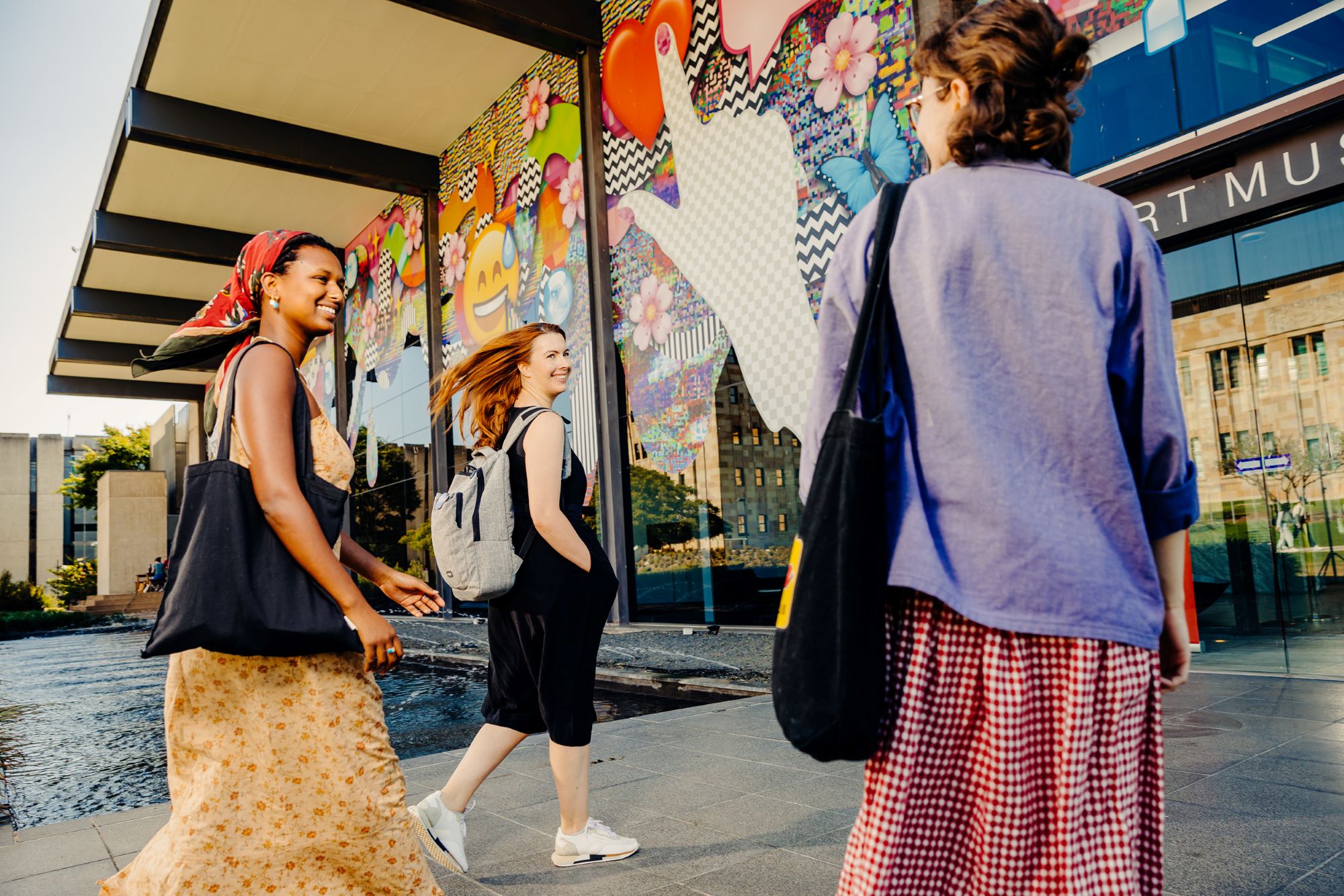 Three students walking towards the Art Museum