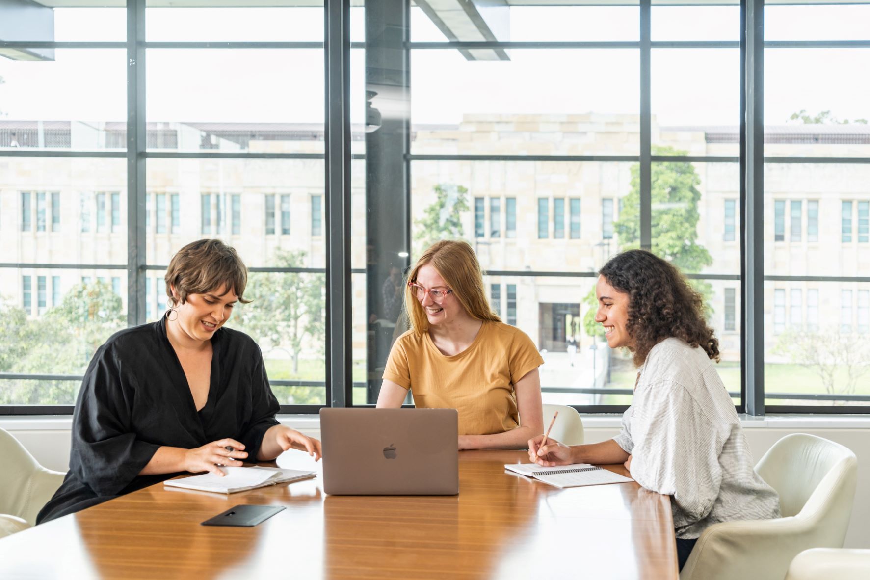 Eva having a meeting with her team in a boardroom