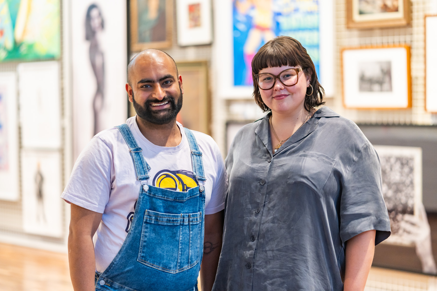 Two people standing together and smiling at the camera