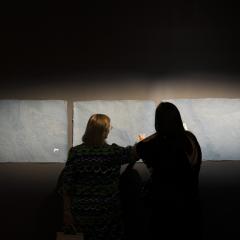 Two people viewing an artwork