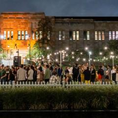 People at an evening event on the Art Museum lawn