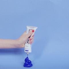 Still from an artwork by Elise Rasmussen showing a hand  squeezing ultramarine paint out of a tube
