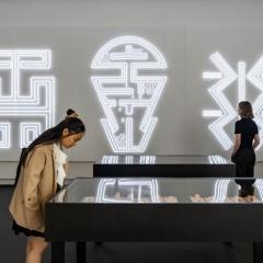 Two people viewing an artwork