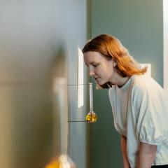 A person smelling a scented artwork by Ensayos