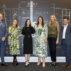 Tim Dunne stands next to members of the curatorial team