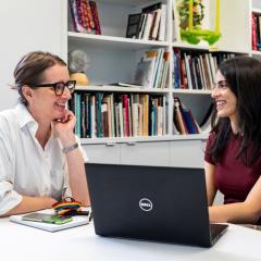 Two people sitting at a desk together