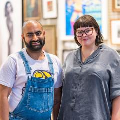 Two people standing together and smiling at the camera